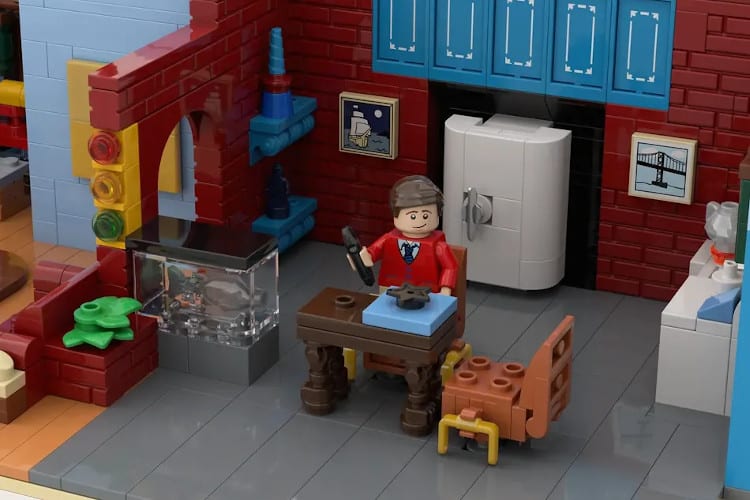 Mister Rogers LEGO minifig sitting on a couch
